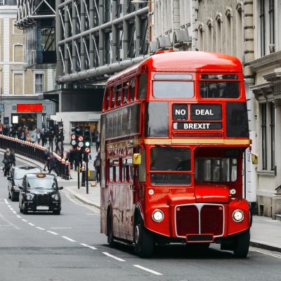 Heritage Routemaster Bus operating in a busy Central London street with traditional black cab on background. Written No Deal Brexit as destination in mock-up to the Leave the EU campaign