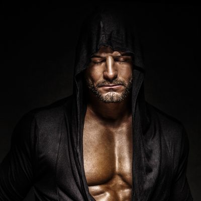 Portrait of handsome man with closed eyes wearing hood.